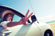 stock-photo-36510110-woman-making-a-peace-sign-while-driving